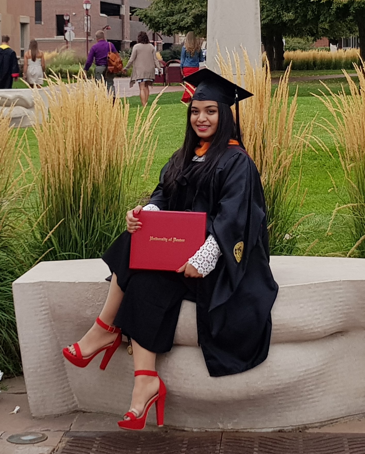 Photo of female-presenting individual in commencement clothing