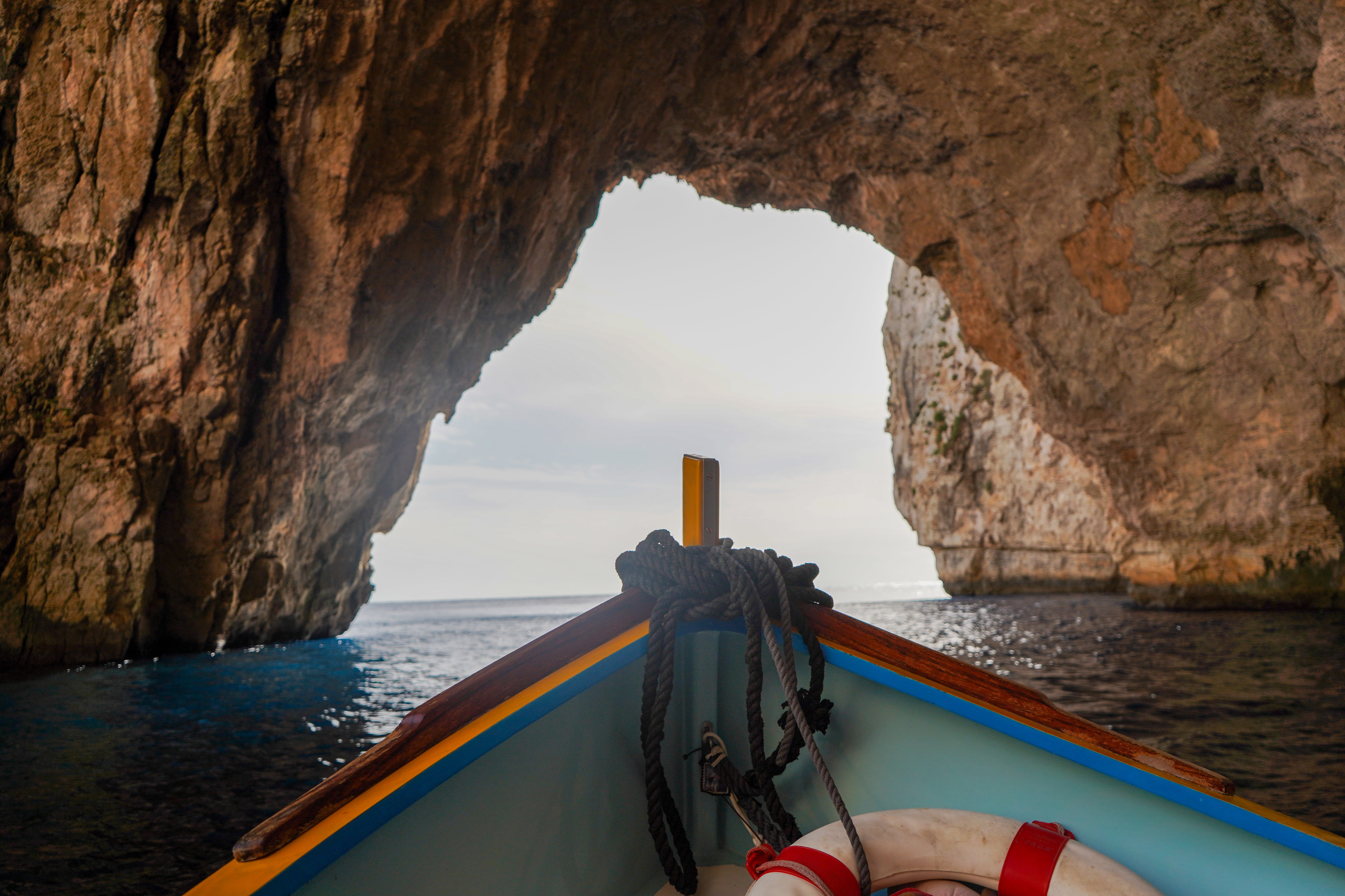 Front of boat in foreground of grotto opening