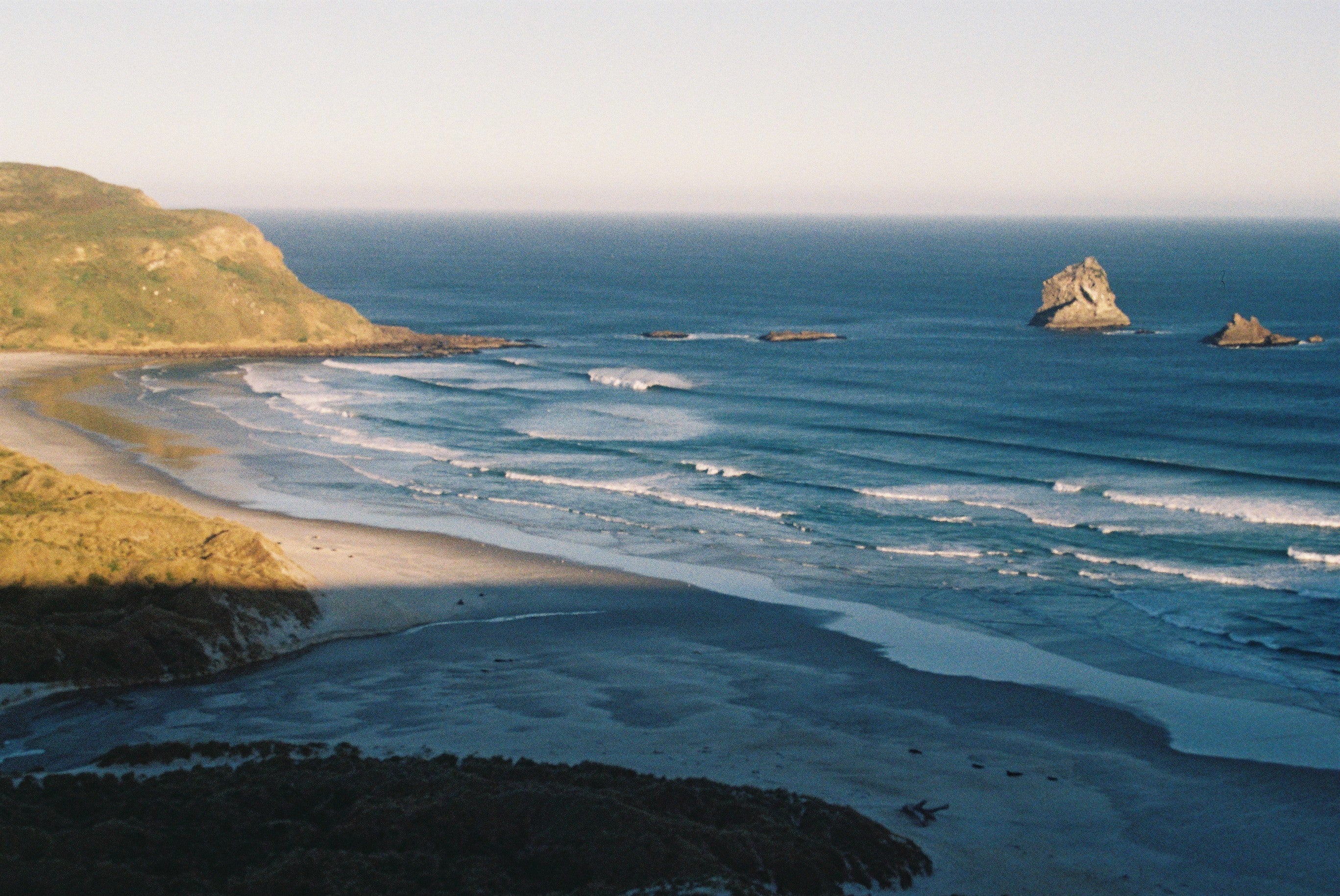 Sandy beach with rocks in water